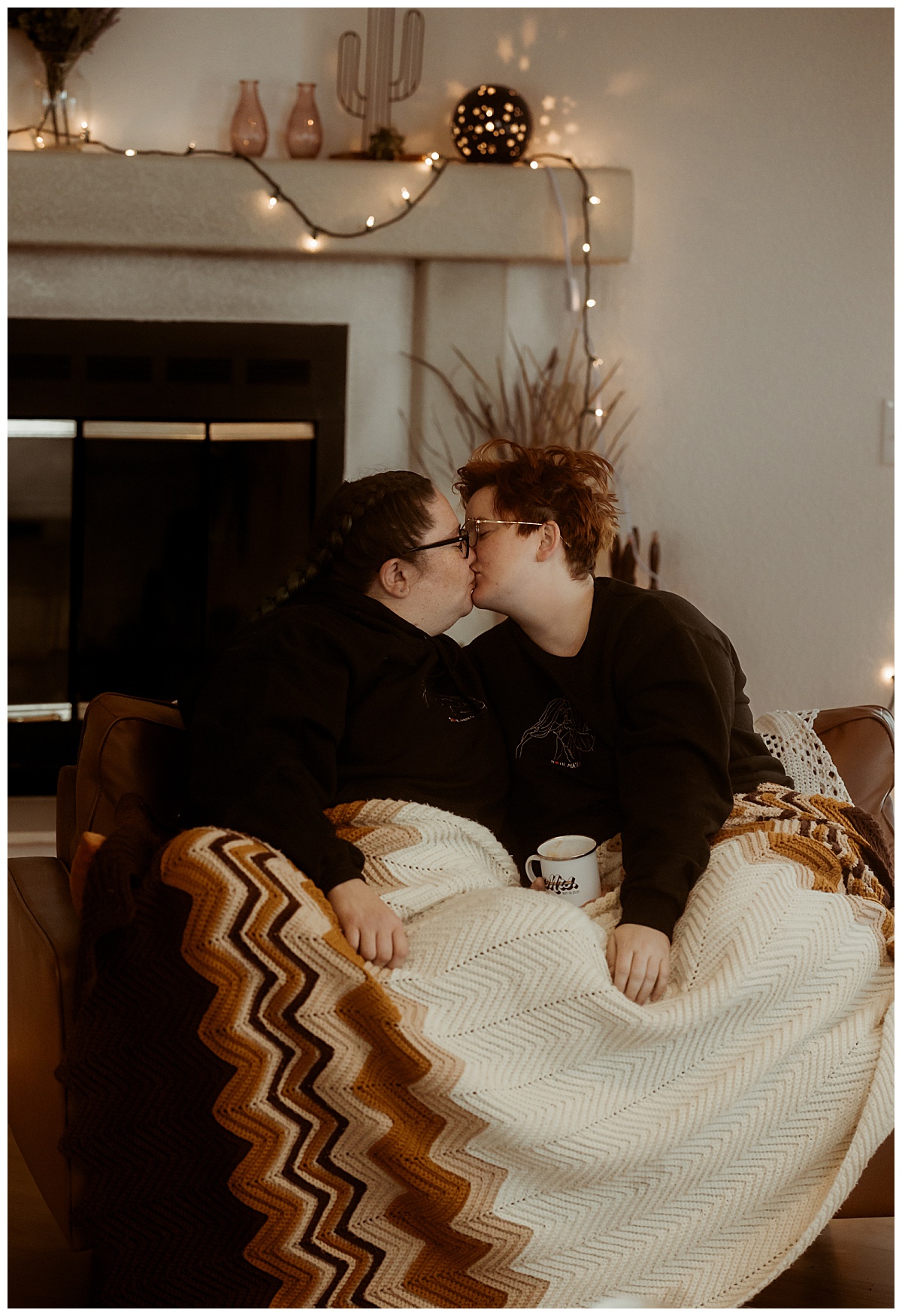 couple sits under blanket and kisses at Joshua Tree elopement
