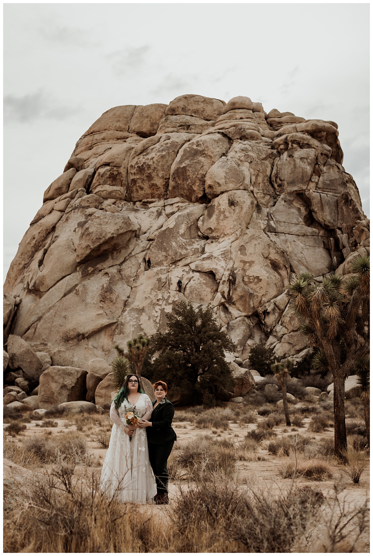 two women stand together in desert in formal attire by Brea Warren Photo